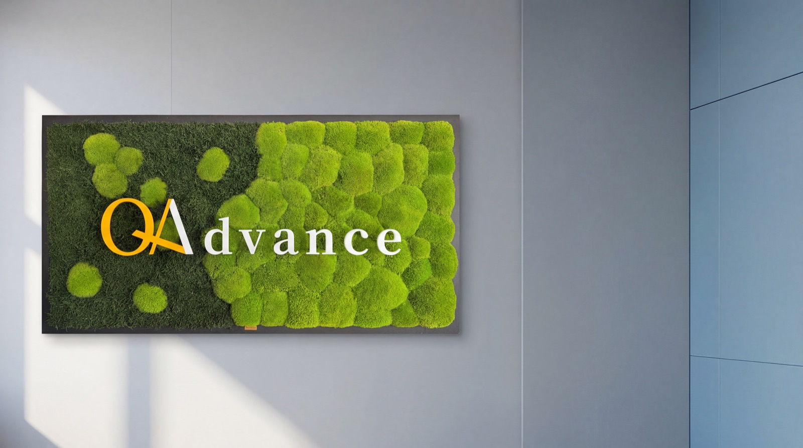 QAdvance-Logo auf einer Mooswand im Büro in Aachen